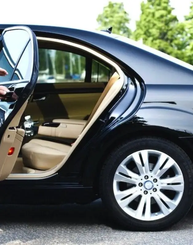Black car with open rear door.