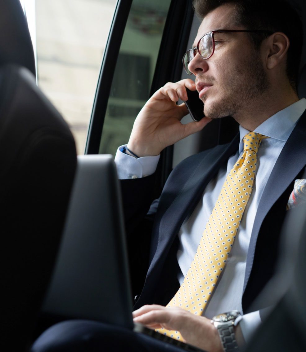 about-second-image Man in suit talking on cell phone.
