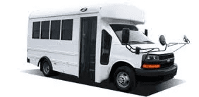 blob-6da728b A white shuttle bus with large windows and side mirrors.
